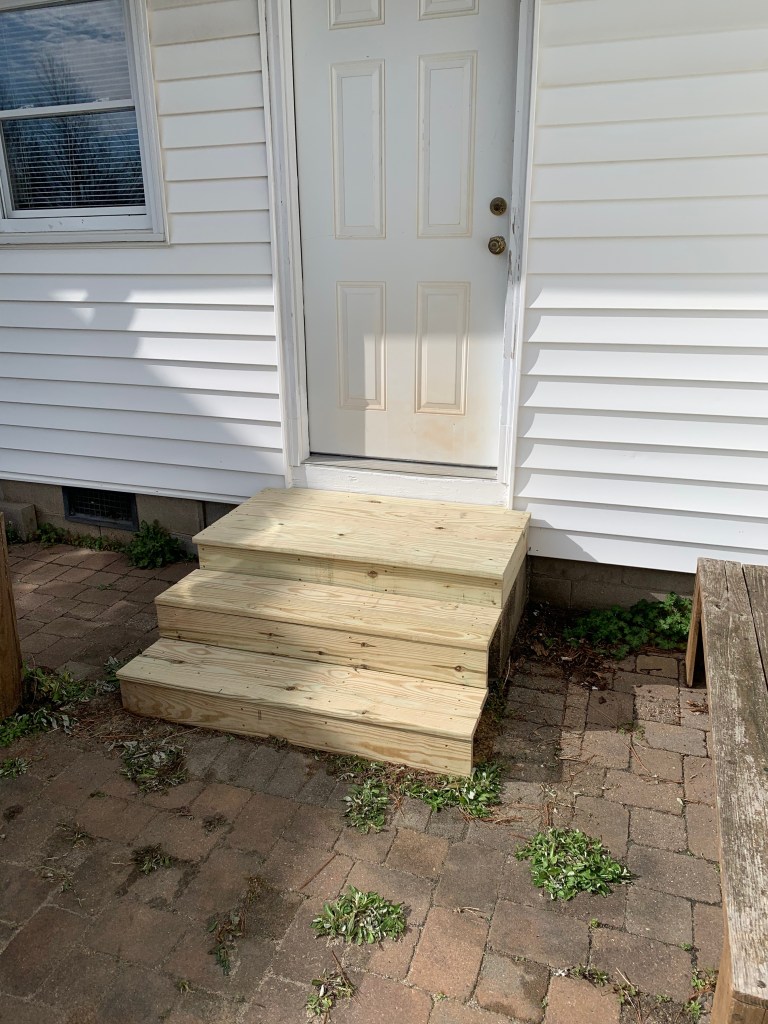 Handyman replaced rotted stoop with pressure treated lumber.