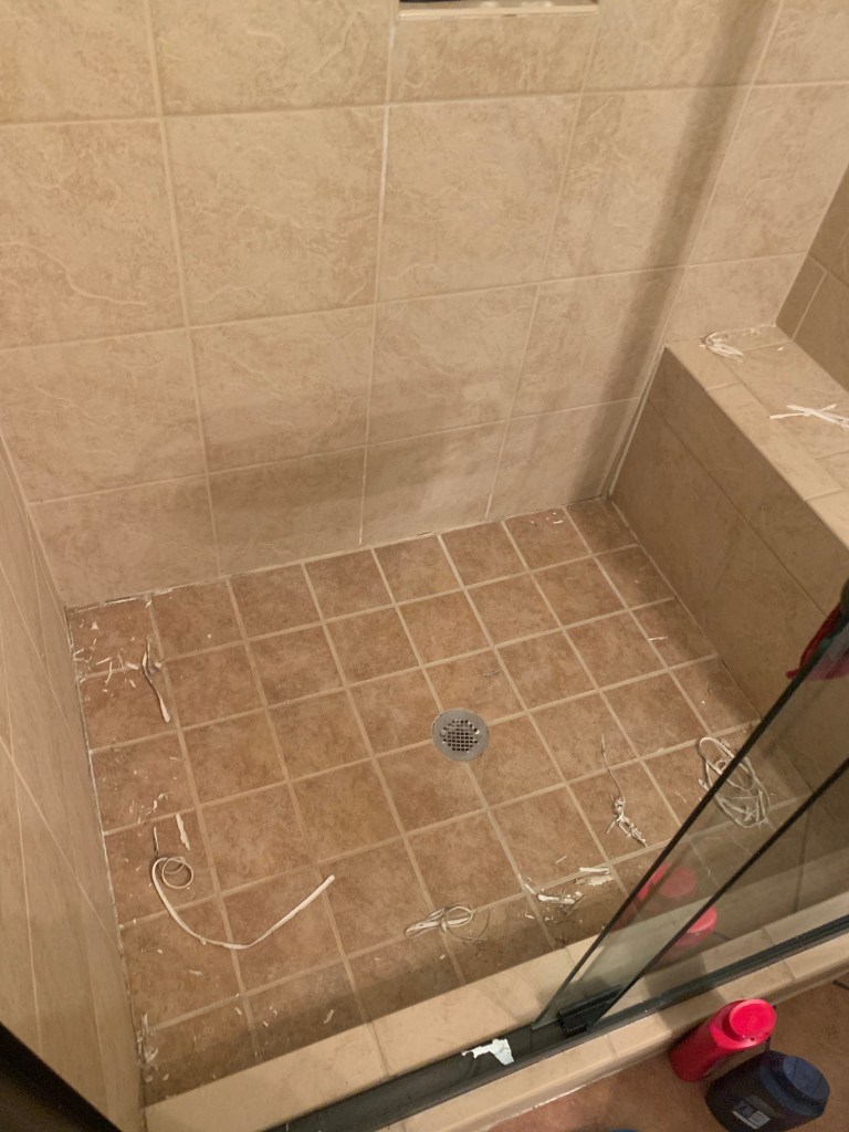 Check It Off Handyman removes old shower caulk to ensure new caulk adheres and protects.