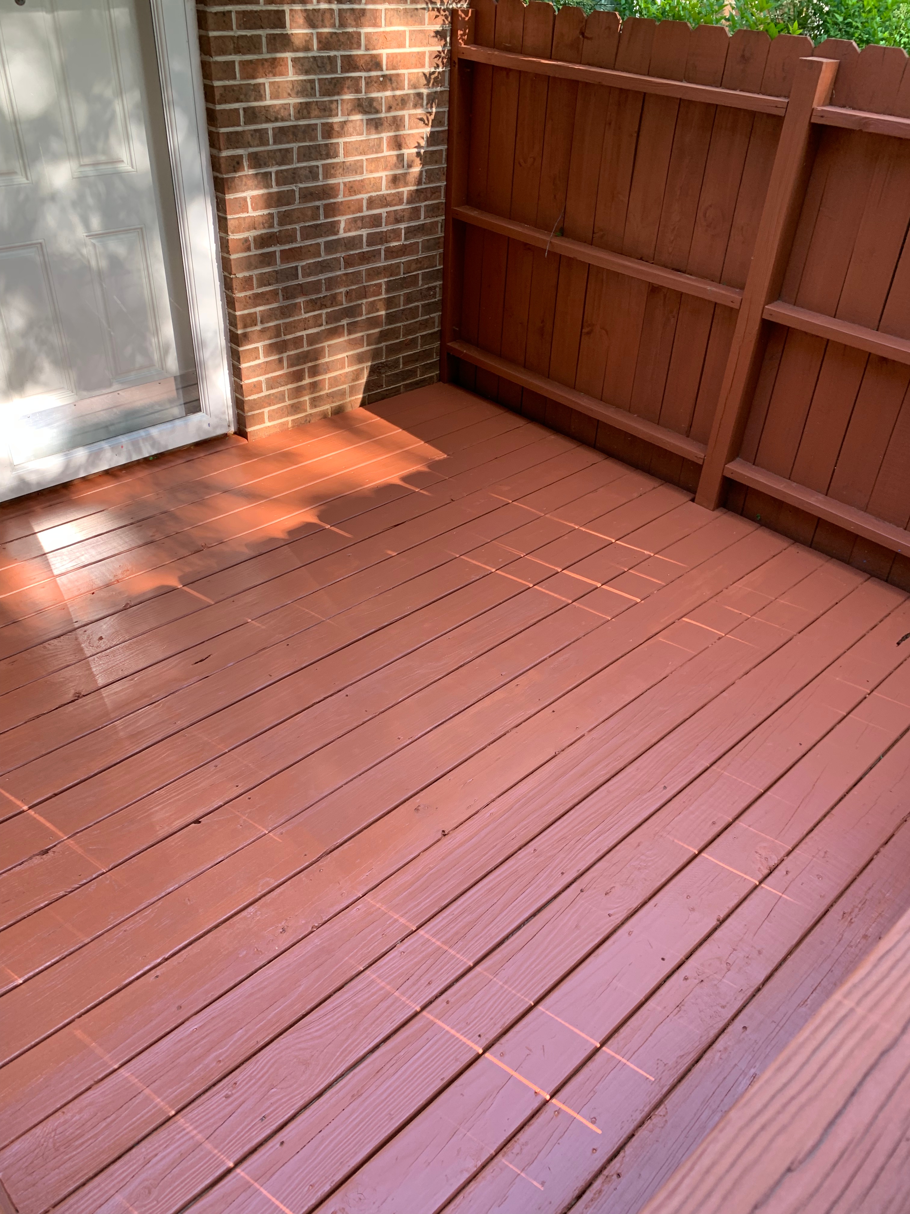 Townhome deck after pressure washing and new stain.