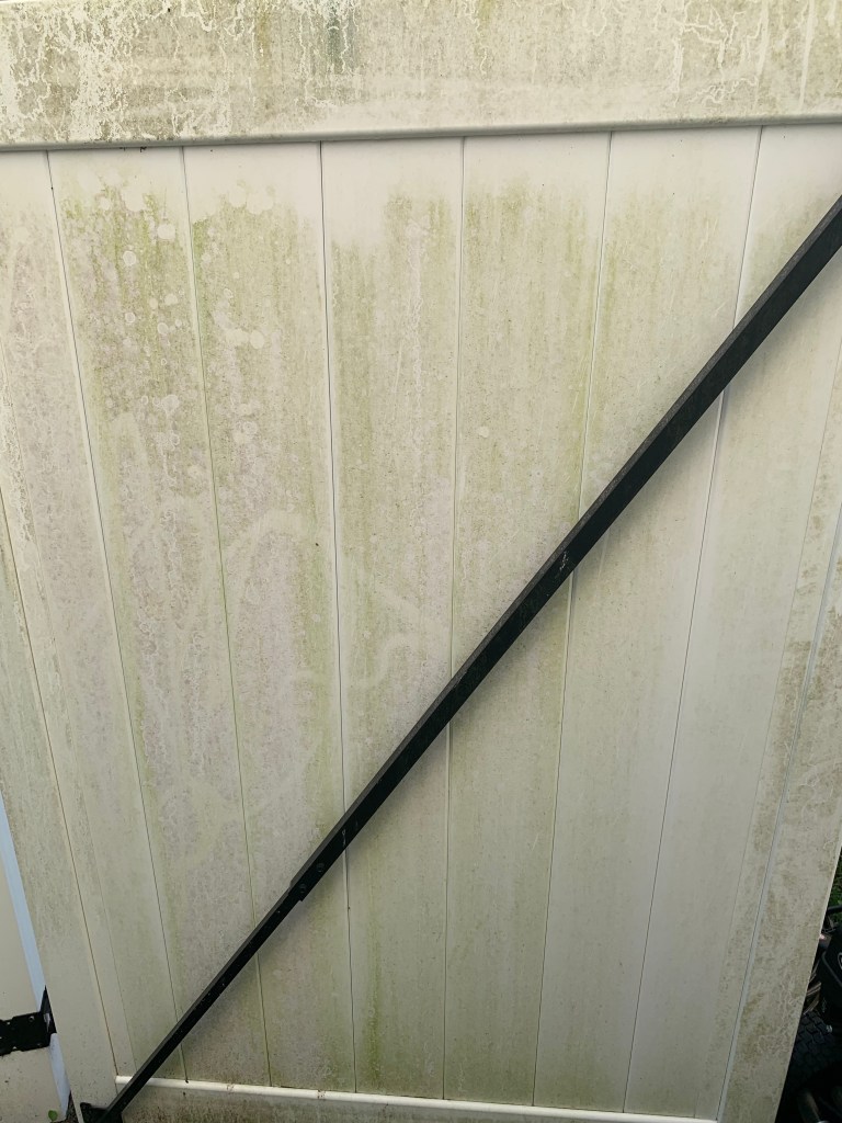 Making the backyard enjoyable again by pressure washing grimy vinyl fence in Raleigh, NC.