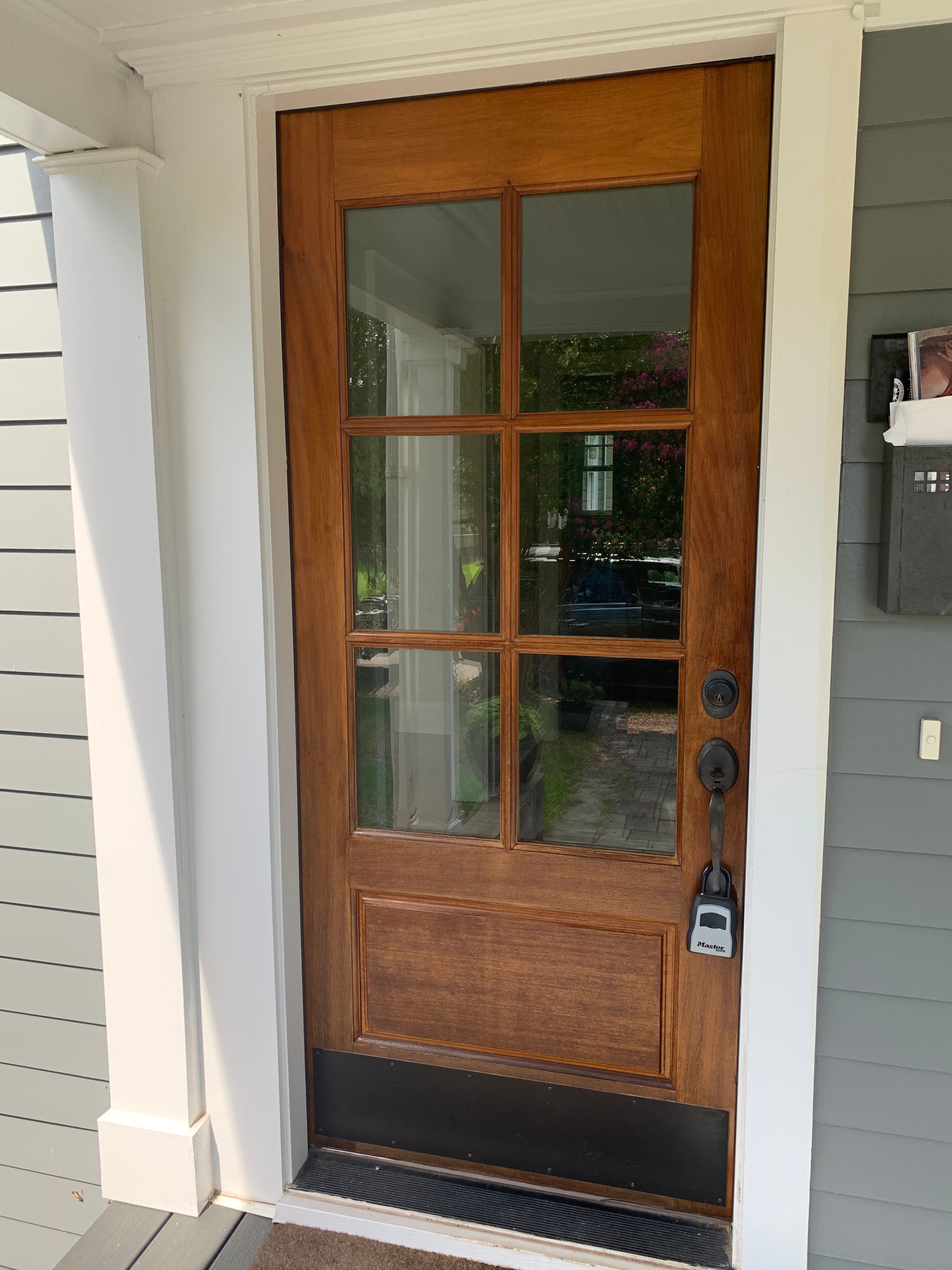 Check It Off Handyman stained front entry door in Raleigh to prepare home for sale.