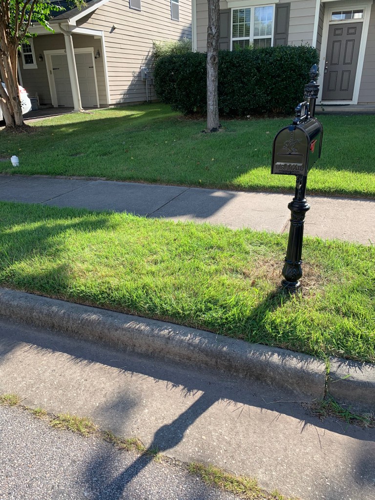 Check It Off Handyman reset the post in new concrete, sanded and painted the post, and installed a new mailbox.